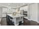 Updated kitchen featuring white cabinets and large center island at 9802 Summer Bliss Ave, Las Vegas, NV 89149