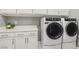 Laundry room with white cabinets, LG washer and dryer, and countertop at 9802 Summer Bliss Ave, Las Vegas, NV 89149