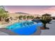 Stunning pool with a rock waterfall and lush landscaping at 9802 Summer Bliss Ave, Las Vegas, NV 89149