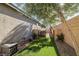 Landscaped backyard with artificial turf and gated access at 9820 Maiden Pink Ave, Las Vegas, NV 89149