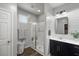 Modern bathroom with double vanity, shiplap feature wall, and walk-in shower at 9820 Maiden Pink Ave, Las Vegas, NV 89149