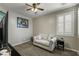 Bedroom with loveseat, window shutters, and ceiling fan at 9820 Maiden Pink Ave, Las Vegas, NV 89149