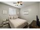 Cozy bedroom with ceiling fan and neutral color palette at 9820 Maiden Pink Ave, Las Vegas, NV 89149