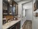 Coffee bar with granite countertop, dark cabinetry, and cork backsplash at 9820 Maiden Pink Ave, Las Vegas, NV 89149