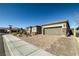 Single-story home with attached garage and landscaped front yard at 9820 Maiden Pink Ave, Las Vegas, NV 89149