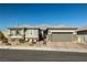 Single-story home with gray exterior, stone accents, and a two-car garage at 9820 Maiden Pink Ave, Las Vegas, NV 89149