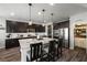 Kitchen features a large island, pantry, and dark cabinetry at 9820 Maiden Pink Ave, Las Vegas, NV 89149