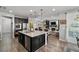 Modern kitchen with large island, stainless steel appliances, and hardwood floors at 9820 Maiden Pink Ave, Las Vegas, NV 89149