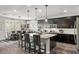 Spacious kitchen with granite island, dark cabinetry, and stainless steel appliances at 9820 Maiden Pink Ave, Las Vegas, NV 89149