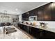 Modern kitchen with white subway tile backsplash and dark cabinetry at 9820 Maiden Pink Ave, Las Vegas, NV 89149