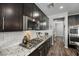 Modern kitchen with gas cooktop and white subway tile backsplash at 9820 Maiden Pink Ave, Las Vegas, NV 89149