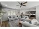 Bright living room features hardwood floors, neutral sofas, and a ceiling fan at 9820 Maiden Pink Ave, Las Vegas, NV 89149