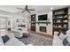 Living area with fireplace, built-in shelving, and hardwood floors at 9820 Maiden Pink Ave, Las Vegas, NV 89149