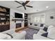 Living room with fireplace, built-in shelving, and hardwood floors at 9820 Maiden Pink Ave, Las Vegas, NV 89149