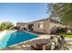 Inviting pool and spa with seating area and lush landscaping at 9820 Maiden Pink Ave, Las Vegas, NV 89149