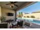 Relaxing backyard oasis with a sparkling pool, patio furniture, and fire pit at 9820 Maiden Pink Ave, Las Vegas, NV 89149