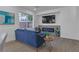 Living room features a blue sofa, fireplace, and large window at 10852 Avenzano St, Las Vegas, NV 89141