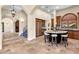 Gourmet kitchen features custom cabinetry, a center island with seating, and stone tile floors at 17 Rue Du Rivoli Pl, Henderson, NV 89011