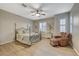Spacious bedroom with light flooring, a large bed, and a comfortable armchair at 2039 Colvin Run Dr, Henderson, NV 89052