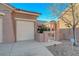 Attached two-car garage with a gate to the side yard at 2039 Colvin Run Dr, Henderson, NV 89052