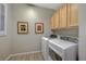 Convenient laundry room with washer, dryer, and overhead cabinets at 2039 Colvin Run Dr, Henderson, NV 89052