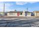 Ranch style home with red door, solar panels, and mature landscaping at 213 Valley Forge Ave, Henderson, NV 89015