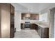 Updated kitchen with dark brown cabinets and granite countertops at 213 Valley Forge Ave, Henderson, NV 89015
