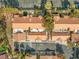 A birdseye view of a townhome community with orange tile roofs, lush trees, landscaping and walking paths at 2292 Cassatt Dr, Henderson, NV 89074