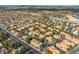 An aerial view of a residential neighborhood in Henderson, Nevada, with lush trees and orange rooftops at 2292 Cassatt Dr, Henderson, NV 89074