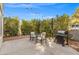 Backyard patio set up with a grill, chairs, and string lights, ideal for outdoor gatherings and relaxing at 2292 Cassatt Dr, Henderson, NV 89074