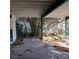 Image looking out from covered carport area with view of overgrown bushes at 2612 Cabot St, Las Vegas, NV 89102