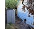 Side of house with a gray storage shed and yard debris at 2612 Cabot St, Las Vegas, NV 89102
