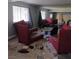 Wide shot of a cluttered living room with a vintage chair at 2612 Cabot St, Las Vegas, NV 89102