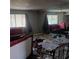 Dilapidated living room with debris, broken furniture, and a mirrored wall reflecting the disarray at 2612 Cabot St, Las Vegas, NV 89102