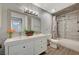 Updated bathroom with double vanity, tile shower, and bathtub at 3152 S Eastern Ave # 26, Las Vegas, NV 89169