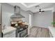 Modern kitchen with gas range and stainless steel range hood at 3152 S Eastern Ave # 26, Las Vegas, NV 89169