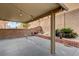 Covered back patio with string lights and landscaped border, perfect for outdoor relaxation at 3349 Morning Amber St, North Las Vegas, NV 89032