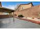 Spacious backyard patio featuring a covered area with string lights and landscaped features at 3349 Morning Amber St, North Las Vegas, NV 89032