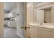 A well lit bathroom with a door to the kitchen at 3349 Morning Amber St, North Las Vegas, NV 89032