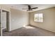 This carpeted bedroom has a window and a ceiling fan, with a view into the hallway at 3349 Morning Amber St, North Las Vegas, NV 89032