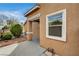 Side view of a tan home with a window and small bushes at 3349 Morning Amber St, North Las Vegas, NV 89032