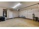 Spacious garage interior with laundry machines, storage and garage door at 3349 Morning Amber St, North Las Vegas, NV 89032