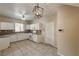 Bright kitchen featuring white cabinets, tile flooring, mosaic backsplash, and a modern light fixture at 3349 Morning Amber St, North Las Vegas, NV 89032
