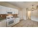A kitchen with modern white appliances, mosaic backsplash, and pendant lighting at 3349 Morning Amber St, North Las Vegas, NV 89032