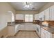 A functional kitchen features white appliances, and nice tile work behind the counters at 3349 Morning Amber St, North Las Vegas, NV 89032