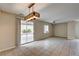 Open-concept living area with tile flooring, a modern light fixture, and access to the backyard at 3349 Morning Amber St, North Las Vegas, NV 89032
