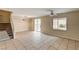 Spacious living room with tile floors, a staircase, and a view of the backyard at 3349 Morning Amber St, North Las Vegas, NV 89032