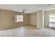 Bright living room featuring tile floors, ceiling fan, and natural light from a large window at 3349 Morning Amber St, North Las Vegas, NV 89032