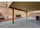 Covered patio with string lights, a garden area and a privacy wall at 3349 Morning Amber St, North Las Vegas, NV 89032