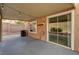Covered patio with string lights features a garden area, privacy wall and access to the house at 3349 Morning Amber St, North Las Vegas, NV 89032